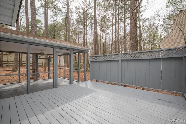 wooden terrace with fence and a sunroom