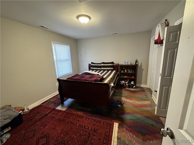 bedroom with visible vents and baseboards