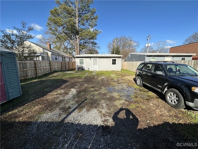 view of yard with fence and an outbuilding