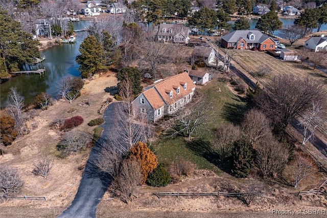 drone / aerial view with a water view and a residential view