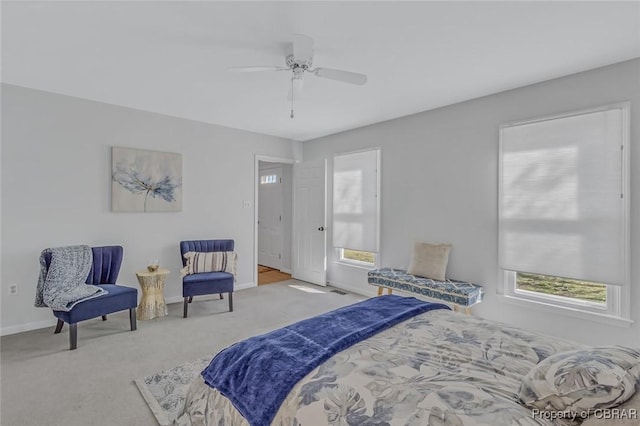 bedroom with baseboards, ceiling fan, and light colored carpet