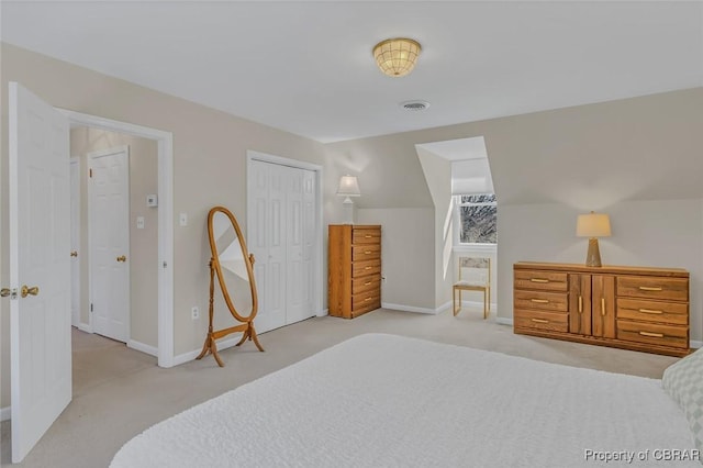 bedroom with light carpet, baseboards, visible vents, and a closet