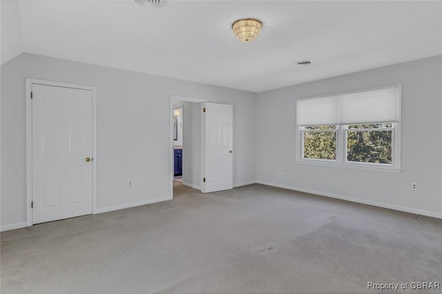 unfurnished bedroom featuring visible vents, baseboards, and light colored carpet