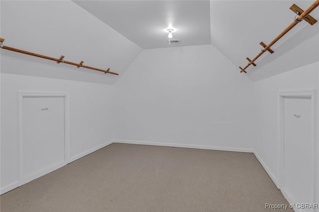 bonus room with carpet floors, visible vents, vaulted ceiling, and baseboards