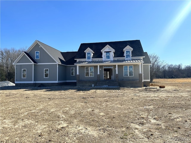 view of front of house featuring a standing seam roof and metal roof