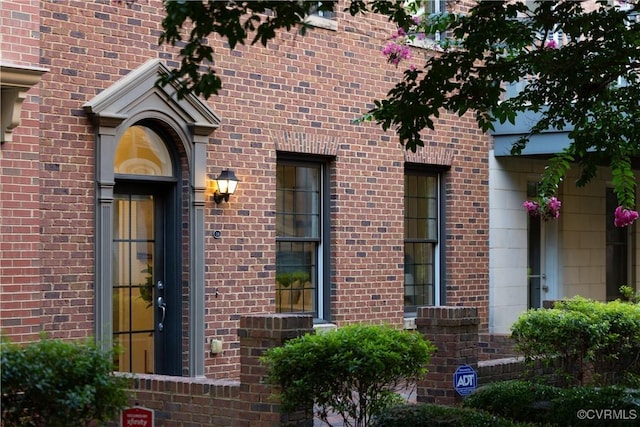 doorway to property with brick siding