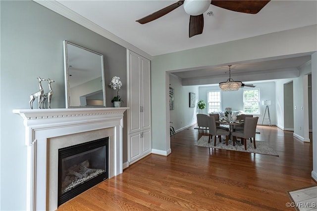 114 Cedar Works Row, Henrico, VA 23231 - dining space featuring a glass covered fireplace, baseboards, ceiling fan with notable chandelier, and wood finished floors