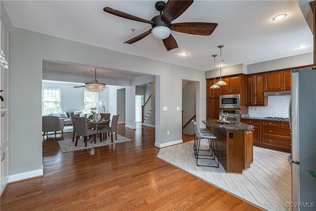 114 Cedar Works Row, Henrico, VA 23231 - kitchen with appliances with stainless steel finishes, ceiling fan, light wood-type flooring, and brown cabinets