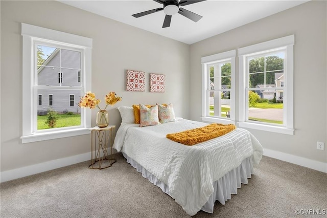 carpeted bedroom featuring a ceiling fan and baseboards