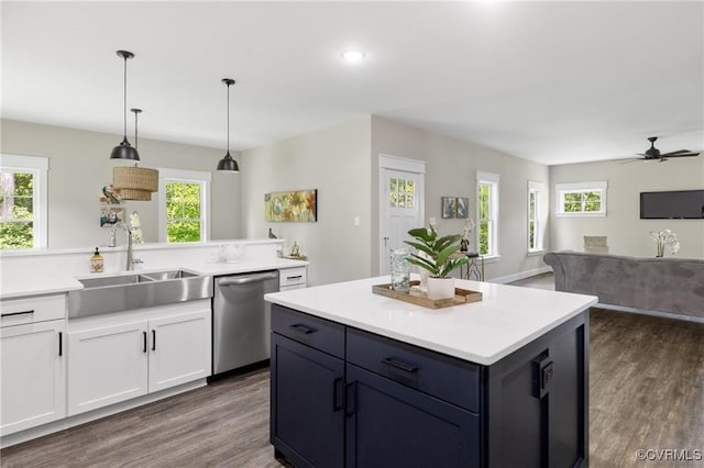 kitchen featuring a sink, white cabinets, light countertops, and stainless steel dishwasher