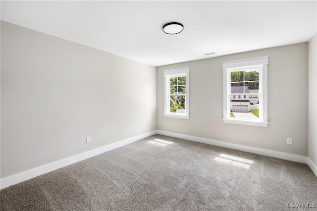 carpeted spare room with baseboards