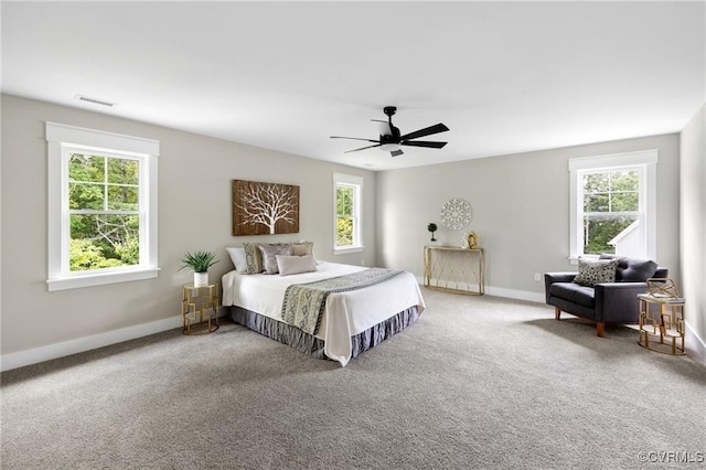 bedroom featuring a ceiling fan, carpet, visible vents, and baseboards