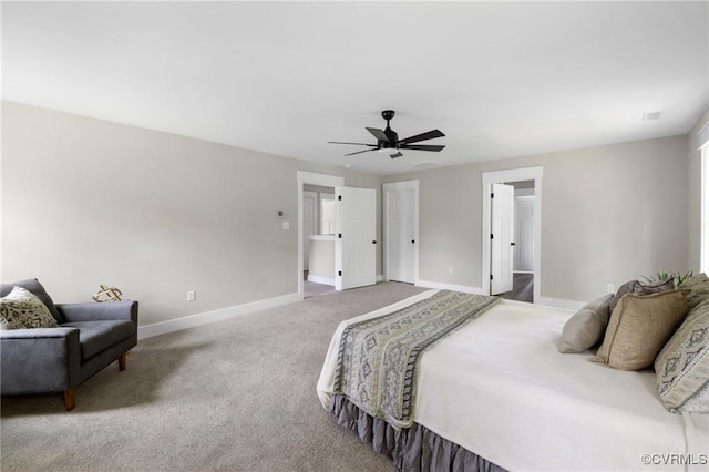 carpeted bedroom with ceiling fan and baseboards