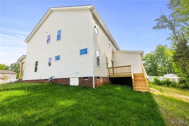 back of property with crawl space, a lawn, a deck, and stairs