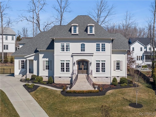 french country home with a shingled roof, fence, french doors, crawl space, and a front lawn