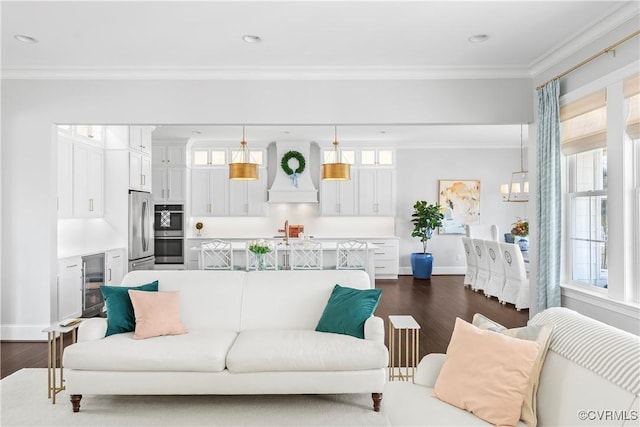 living room with baseboards, wine cooler, ornamental molding, and dark wood-type flooring