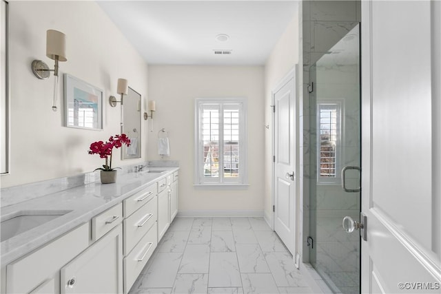 bathroom featuring double vanity, visible vents, baseboards, marble finish floor, and a shower stall