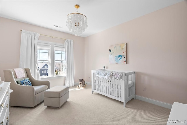 bedroom featuring carpet floors, a nursery area, baseboards, and an inviting chandelier