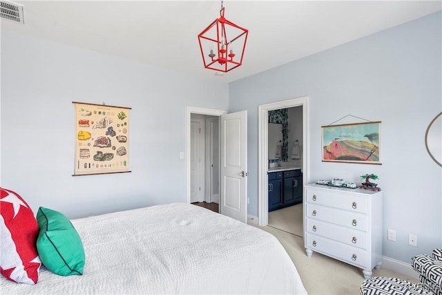 bedroom with baseboards, connected bathroom, visible vents, and light colored carpet