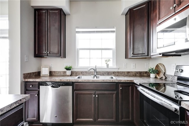 kitchen featuring dark brown cabinets, appliances with stainless steel finishes, and a sink