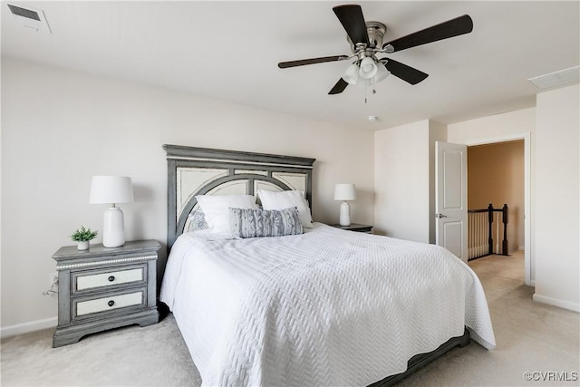 bedroom with light carpet, baseboards, and a ceiling fan