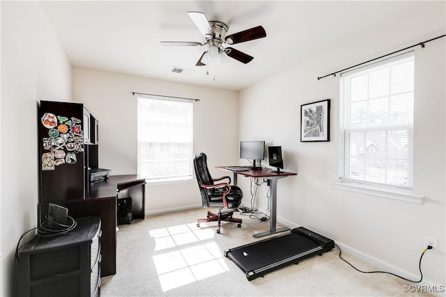 office area featuring ceiling fan, visible vents, baseboards, and light colored carpet