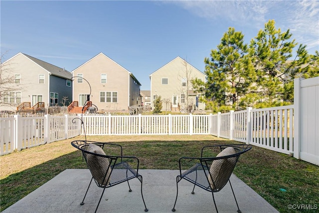 view of patio / terrace featuring a fenced backyard and a residential view