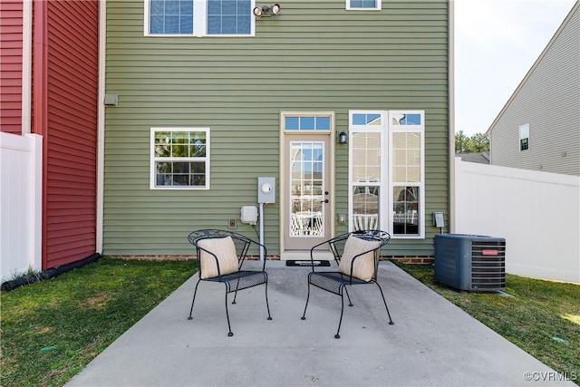 view of patio with cooling unit and fence