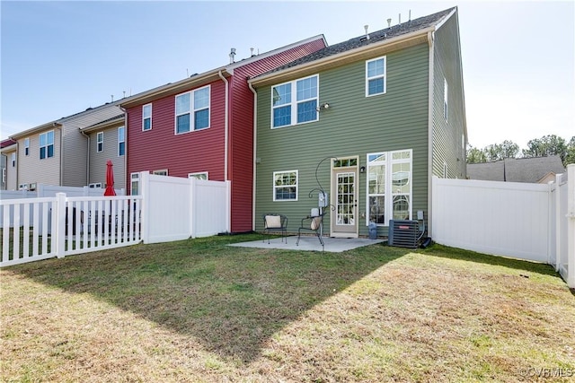 rear view of property with a patio area, a fenced backyard, a yard, and central air condition unit