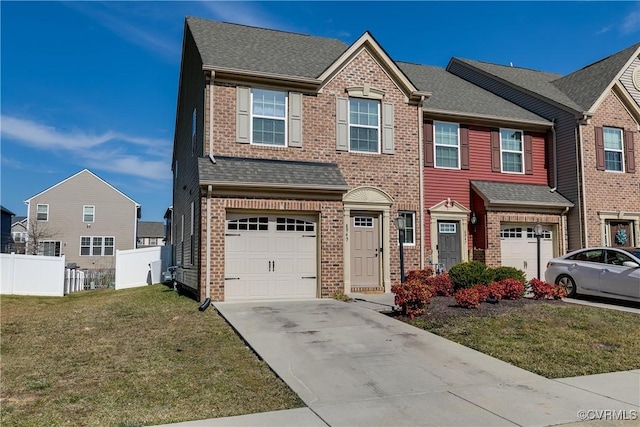 view of front of house with brick siding, a front lawn, an attached garage, and fence