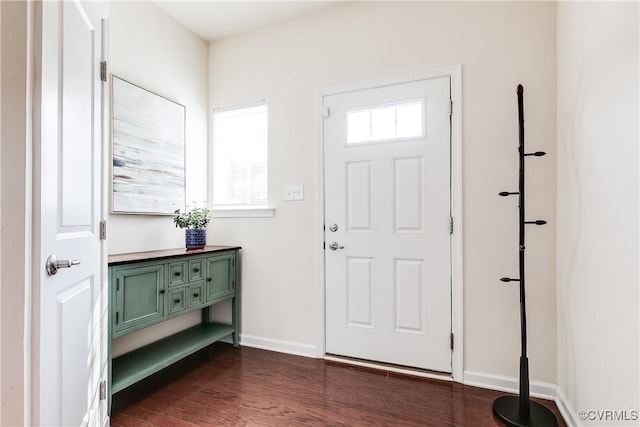 entryway with dark wood-style flooring and baseboards