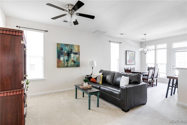 living room with light carpet, visible vents, and baseboards