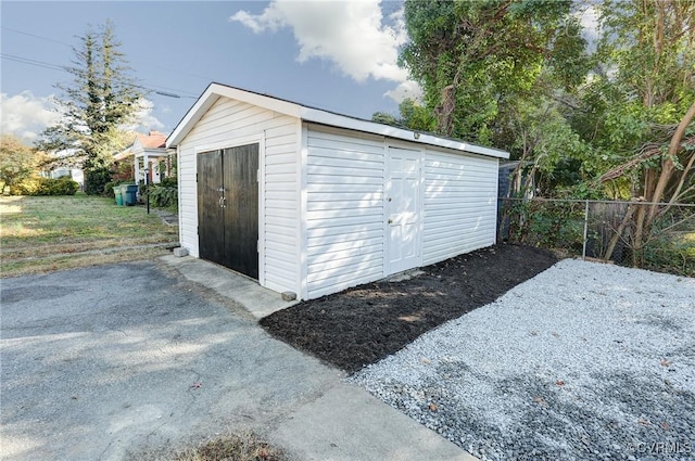 view of shed with fence