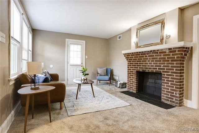 interior space with carpet floors, a fireplace, and visible vents