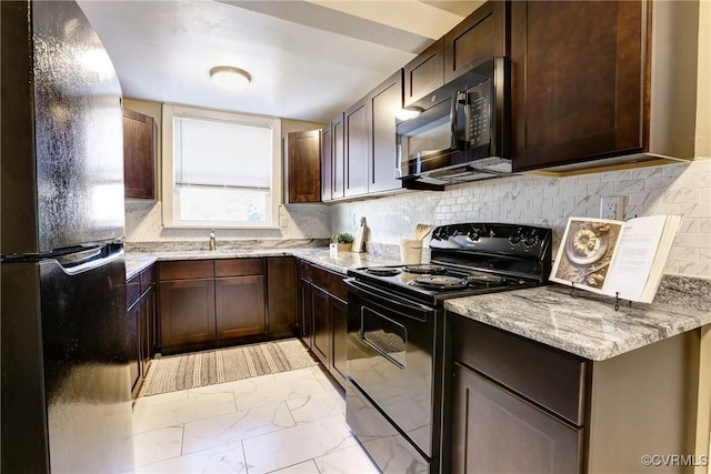 kitchen with black appliances, dark brown cabinetry, and light stone countertops