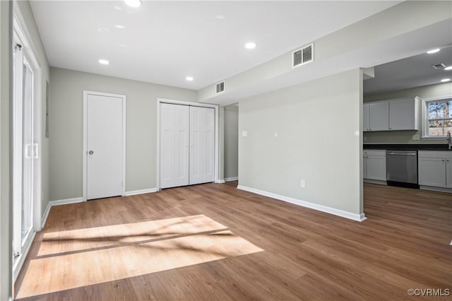 unfurnished bedroom with recessed lighting, visible vents, baseboards, and wood finished floors