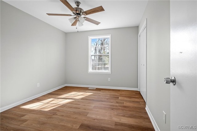 unfurnished bedroom with light wood finished floors, baseboards, and a closet