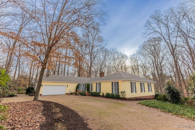 ranch-style home with a front lawn, a chimney, a garage, and dirt driveway