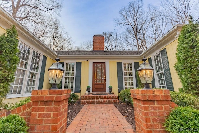 property entrance featuring a chimney