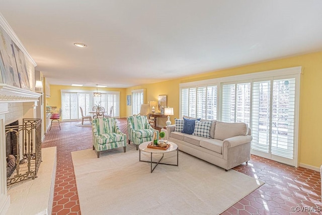 living room featuring baseboards and a tiled fireplace