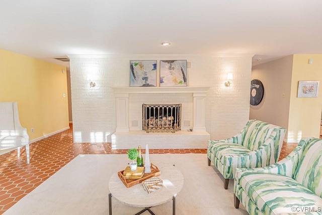 living room with visible vents, brick wall, baseboards, a fireplace, and tile patterned flooring