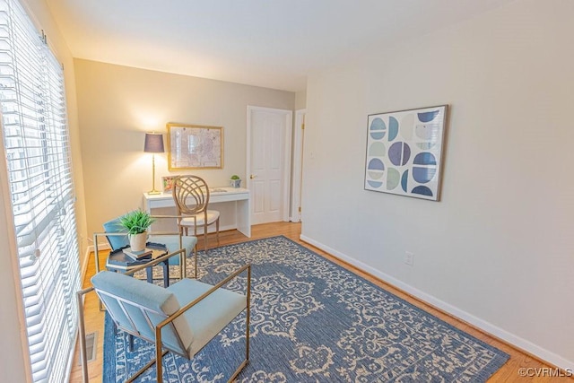 office featuring baseboards and wood finished floors