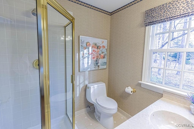 full bathroom with a wealth of natural light, a sink, a shower stall, and wallpapered walls