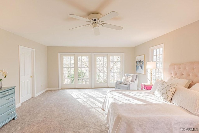 bedroom featuring access to exterior, a ceiling fan, baseboards, and light carpet