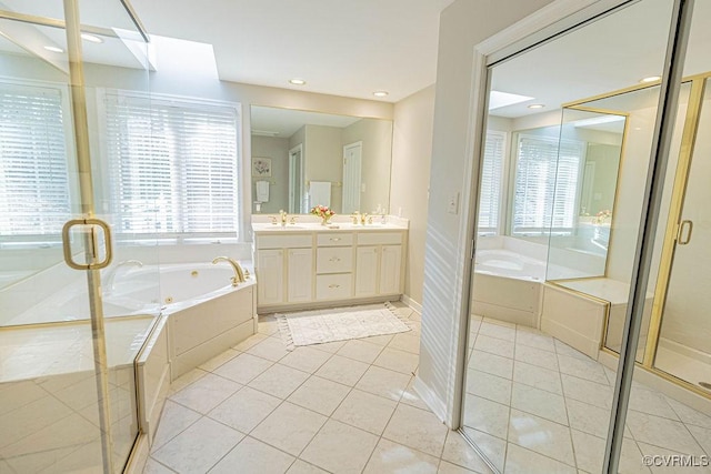 full bath with double vanity, a sink, tile patterned floors, and a whirlpool tub