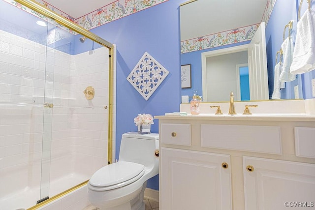 bathroom featuring vanity, toilet, and a stall shower