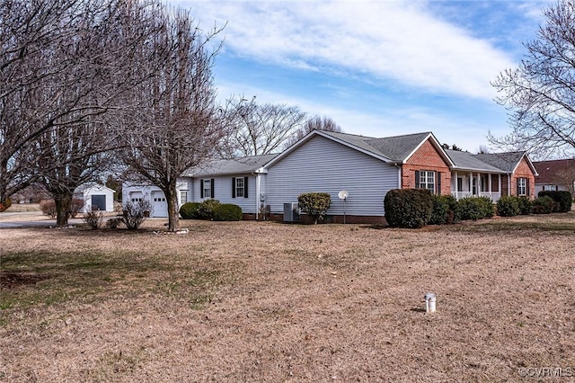 view of front of property with brick siding, cooling unit, and a garage