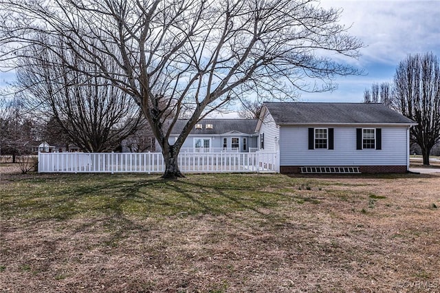 exterior space featuring a front lawn and fence