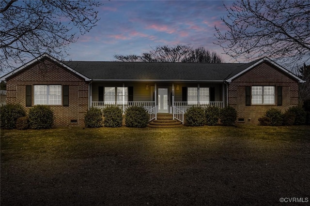 ranch-style home with crawl space, covered porch, and brick siding