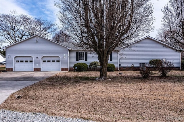 ranch-style home featuring crawl space, an attached garage, and concrete driveway